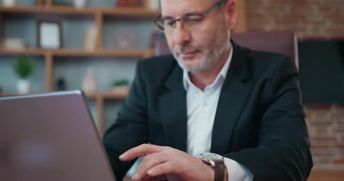 Adult Man Working at Computer in Office