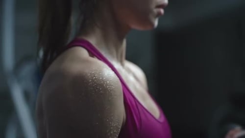 Woman Lifting Dumbbell at Gym for Strength Training