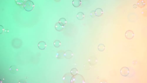Blue and Clear Soap Bubbles on Turquoise and Light Pink, Background