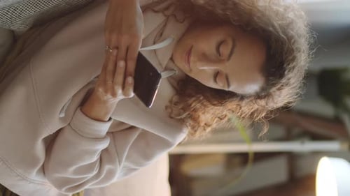 Woman Using Smartphone Indoors During Daytime