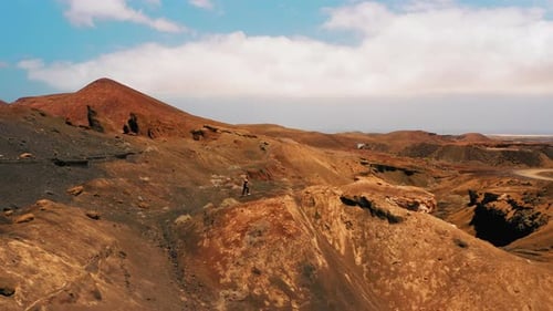 Woman in Sportswear Walks Along the Endless Desert Sandy Hills