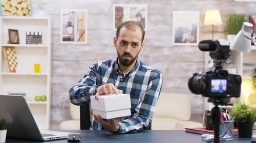 Man Unboxing Cell Phone for Online Video