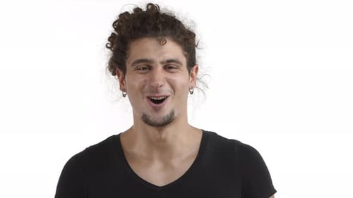 Young Adult Smiles and Makes OK Hand Gesture