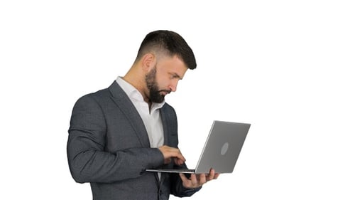 Man Typing on Laptop in Gray Suit
