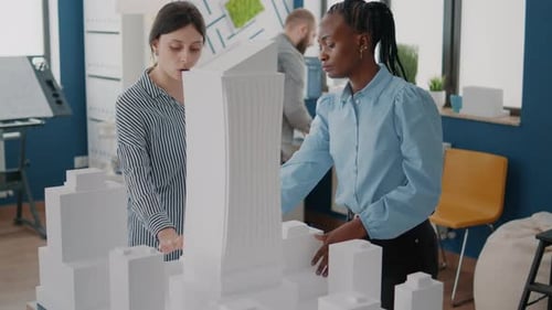 Architects Working with Building Model to Plan Construction Layout