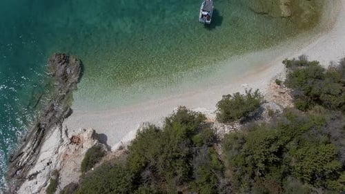 small beach and a boat into the sea