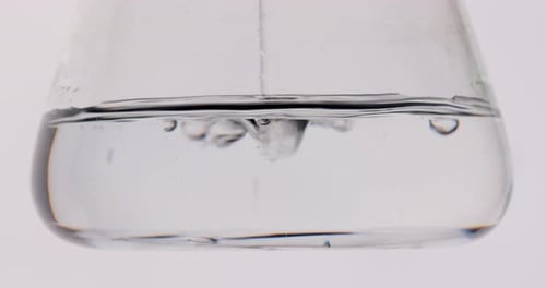 Close-up Shooting. the Flask Is Filling with a Clear Fluid. Experiments in the Laboratory. Search