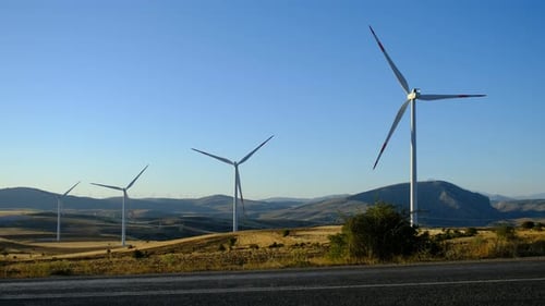 Wind Turbines Rotating in a Mountainous Landscape