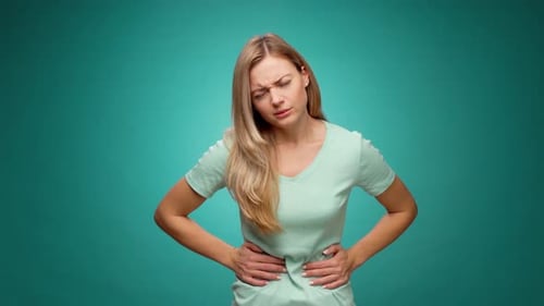 Pretty Young Woman Suffering Stomachache Menstruation Pain Against Mint Background