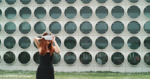 Woman Puts on VR Headset Outside Building
