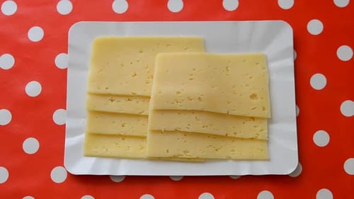 Sliced Cheese on a Plate, One Slice Removed