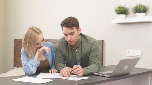 Young Adults Working Together at Home at Desk