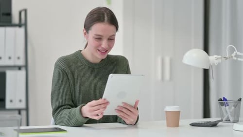 Woman Talking on Tablet Video Call in Office