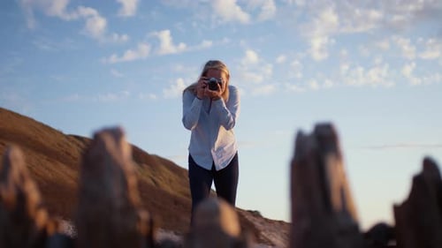Photographer Using Slr Camera On Beach