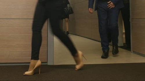Crowd Business People Leave The Office Rooms. Legs Of Crowd People Leaving The Office Rooms