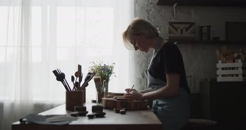 Woman Drawing on Wood in Workshop Studio