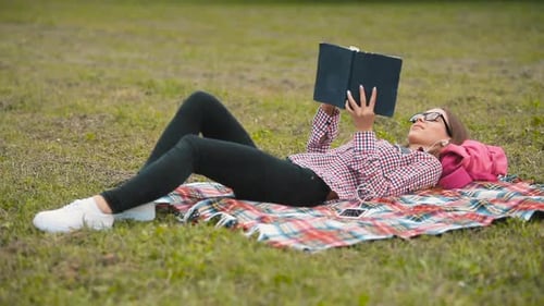 Woman Reading a Book in the Park