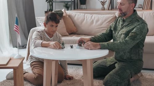 Father and Son Play Toy Soldiers at Home