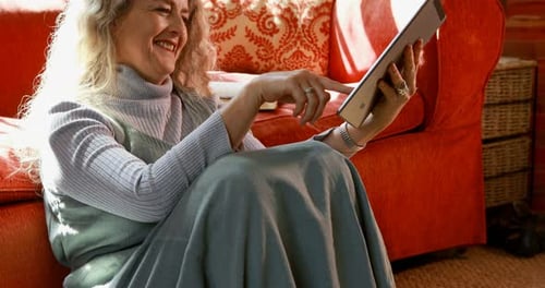 Smiling Woman Using Tablet at Home on Floor