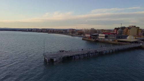 Side View of the Pier on the Black Sea Against the Background of the Sky and Sunset