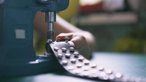 Attaching Metal Rivets to Material With Machine