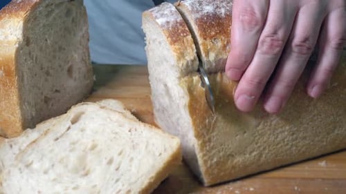 Close Shot of Rustic Bread Being Sliced With a Bread Knife