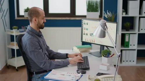 Adult Working at Computer in Bright Modern Office