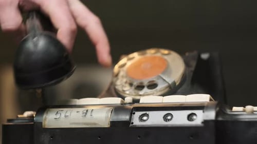 Old Soviet State Telephone Man Presses Button and Picks Up the Receiver