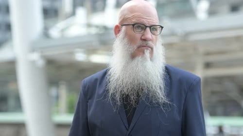 Face of Happy Mature Bearded Bald Businessman Smiling in the City Outdoors
