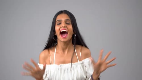 Happy and excited Indian girl jumping and clapping