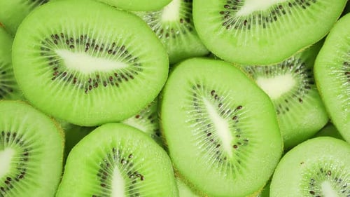 Slow Motion of Rotation Ripe Green Sliced Kiwi