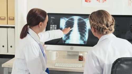 Doctors Analyzing Chest X-Ray in Office Setting