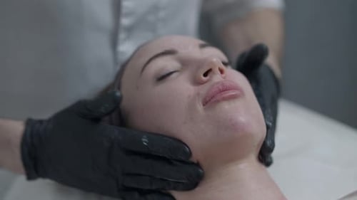 Woman Receiving Facial Massage in a Spa
