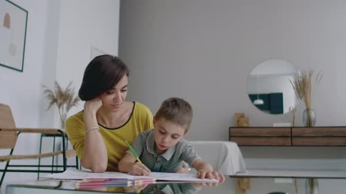 Woman Watches Child Drawing at Modern Home