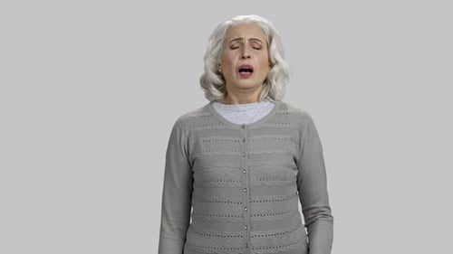 Senior Woman Sneeze into Tissue