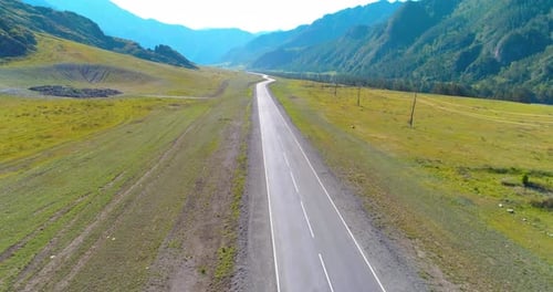 Flight Over Mountain Asphalt Highway Road and Meadow