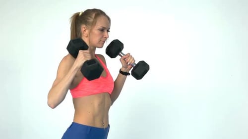 Fitness Woman Doing Exercise With Dumbbells In The Gym