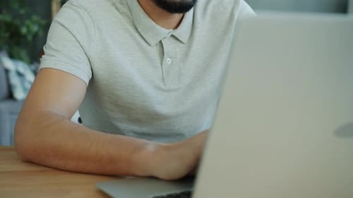 Young Adult Working at Laptop From Home