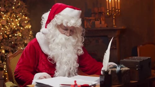 Santa Claus Writing at Desk Near Christmas Tree