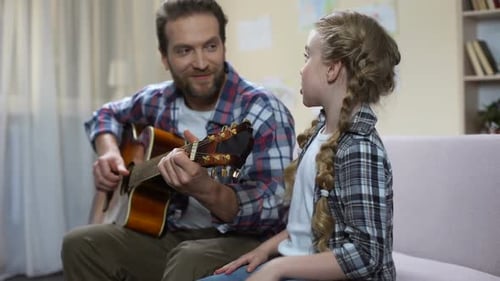 School Girl Singing Father Playing Guitar, Happily Hugging, Having Fun Together