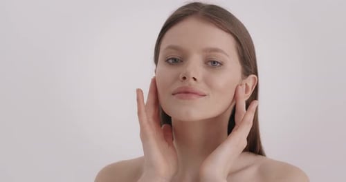 Woman Massaging Face for Beauty and Wellness