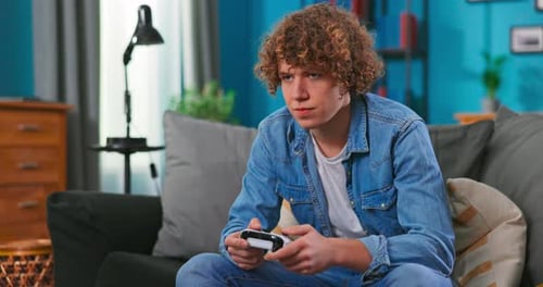 Teen Playing Video Game at Home on Couch
