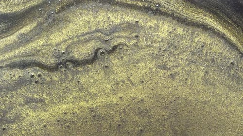 Gold and Black Paint Mixing Abstract Background