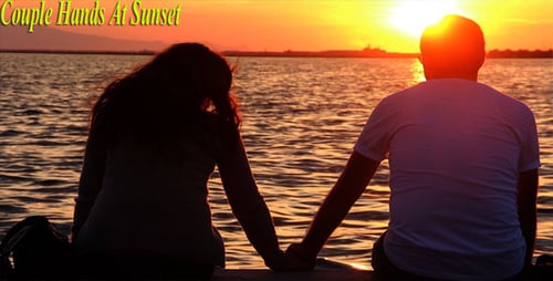 Romantic Couple Holding Hands at Sunset by the Sea
