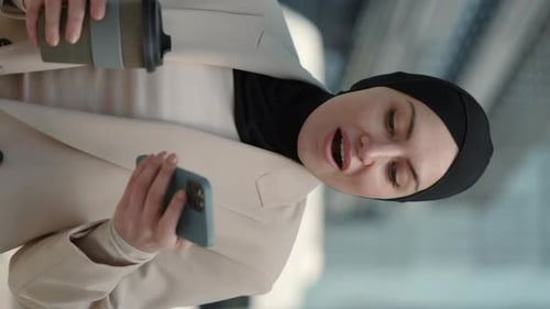 Smiling Woman Holding Phone and Coffee Cup