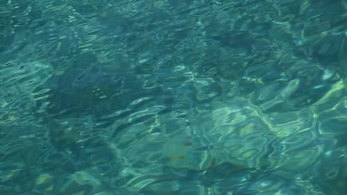 Background of emerald green and turquoise sea ripples
