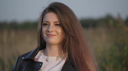 Smiling Woman Posing in a Rural Field