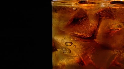 Refreshing Brown Beverage with Ice Cubes Close Up
