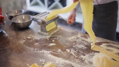 Chef Makes Pasta with Machine in Restaurant Kitchen
