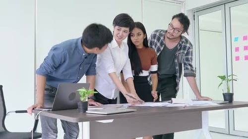 Team Discussing Business Strategy in Modern Office